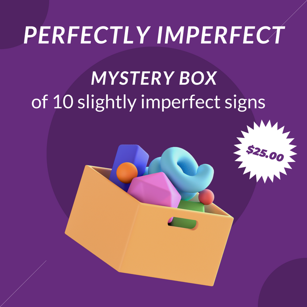 Box full of imperfect wreath signs that have slight blemishes that are sold at outlet prices