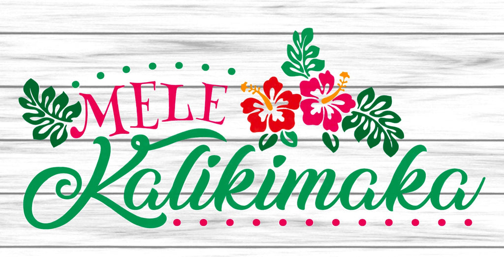 12 inch metal wreath sign with Mele Kalikimaka printed atop a white shiplap background and accented with tropical leaves and hibiscus flowers
