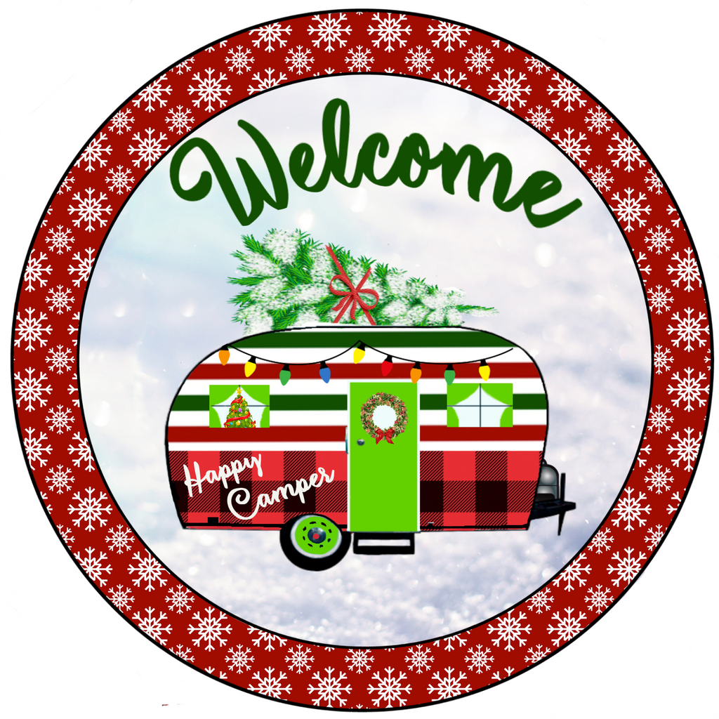 8 inch round metal welcome sign with Happy Camper written on the side and all decorated for Christmas against a snowy background surrounded by white snowflakes against a red background