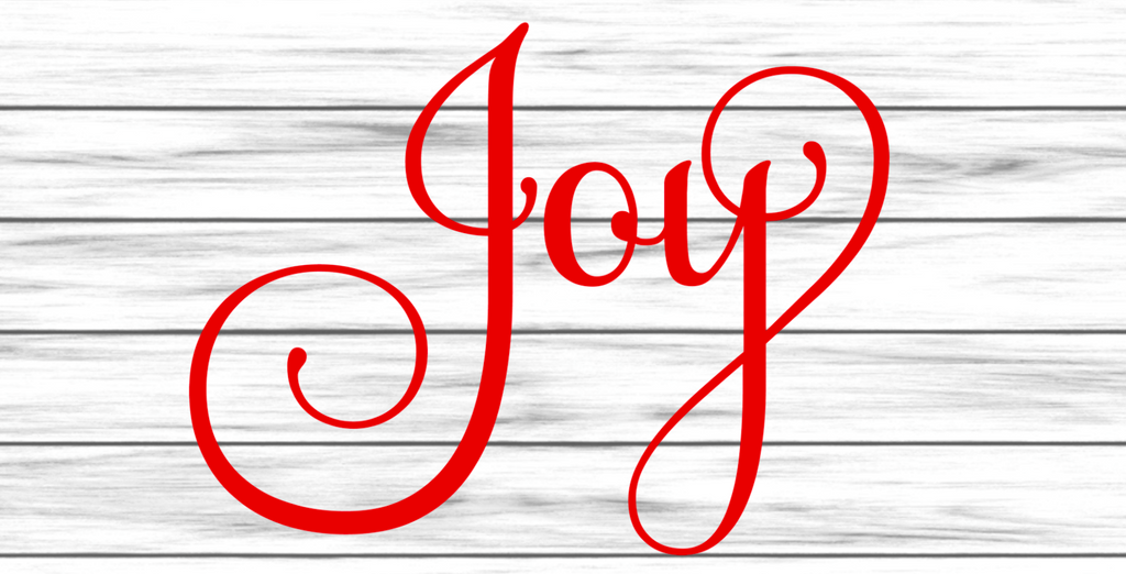 12 inch metal wreath sign with Joy printed in red set against a white colored shiplap background