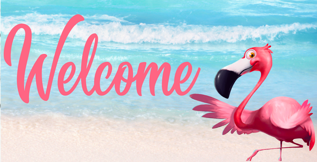 12 inch metal wreath sign with Welcome printed in pink accented by a friendly smiling pink flamingo and is set against a beach with crashing wave background