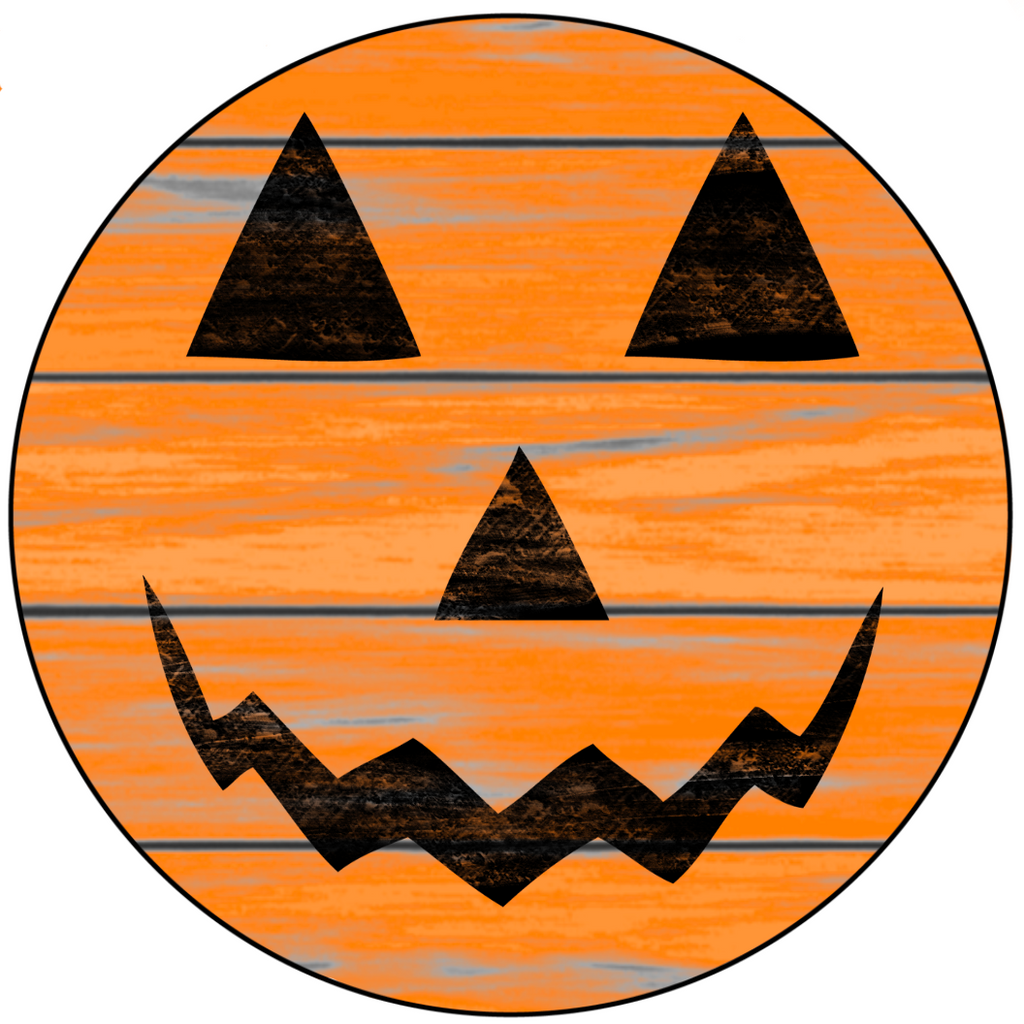 8 inch round metal wreath sign with a classic jack o lantern face set against a orange colored shiplap background