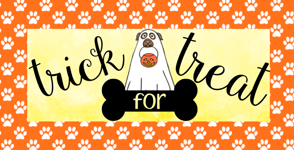 Trick For Treat wreath sign features a dog dressed as a ghost with a pumpkin candy bucket in his mouth and is set against a yellow background surrounded by orange with white dog paws.