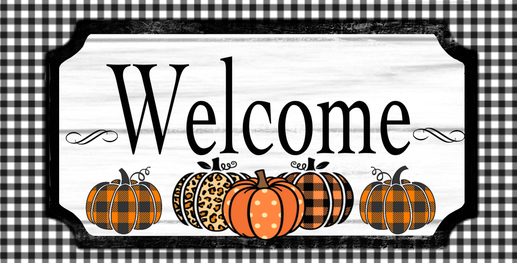 12 inch metal wreath sign with Welcome printed in black above plaid and animal print pumpkins set against an aged white wood background and surrounded by a black and white gingham pattern.